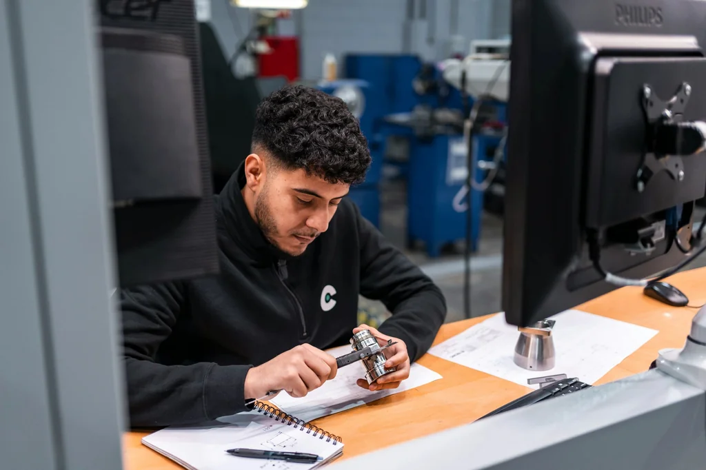 Engineer reviewing custom metal screen drawings and project documents