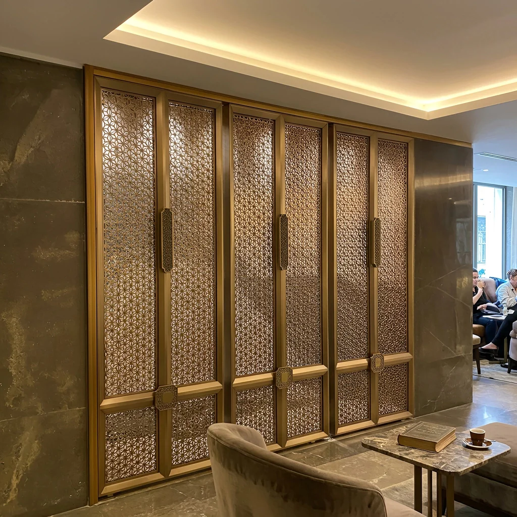 Brushed brass laser-cut screen zoning a boutique hotel lobby lounge — visualization
